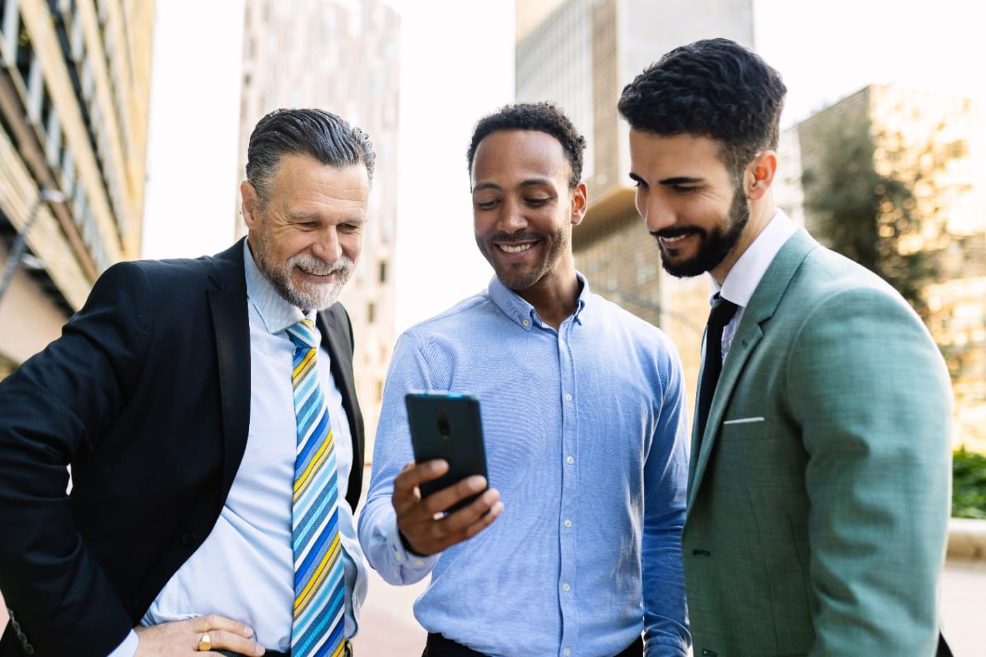 Business people networking and looking at a phone together