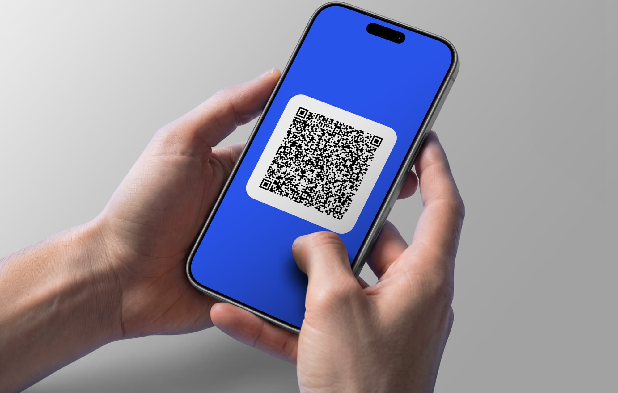 Two hands holding a smartphone with a large QR code on the display